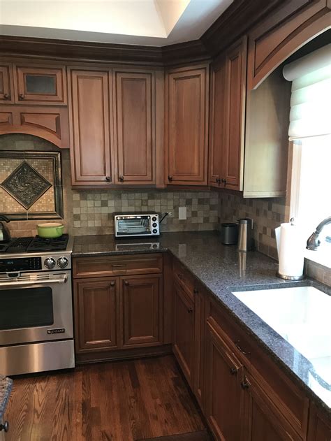 light brown cabinets with stainless steel appliances|brown cabinets with white countertops.